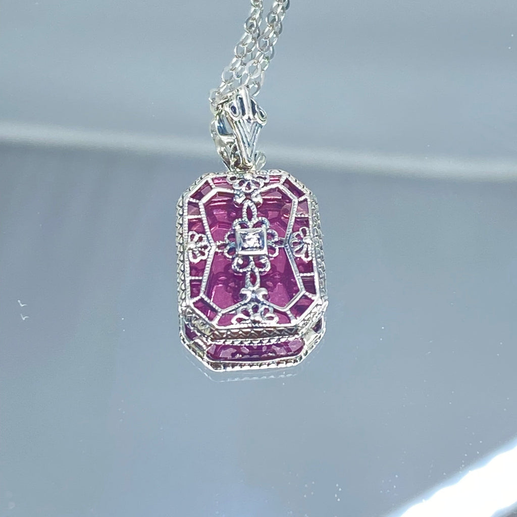 Pink Camphor Glass pendant with a CZ gem inset in the center, sterling silver filigree edging and across the glass face in window pane style, Silver Embrace Jewelry, P203
