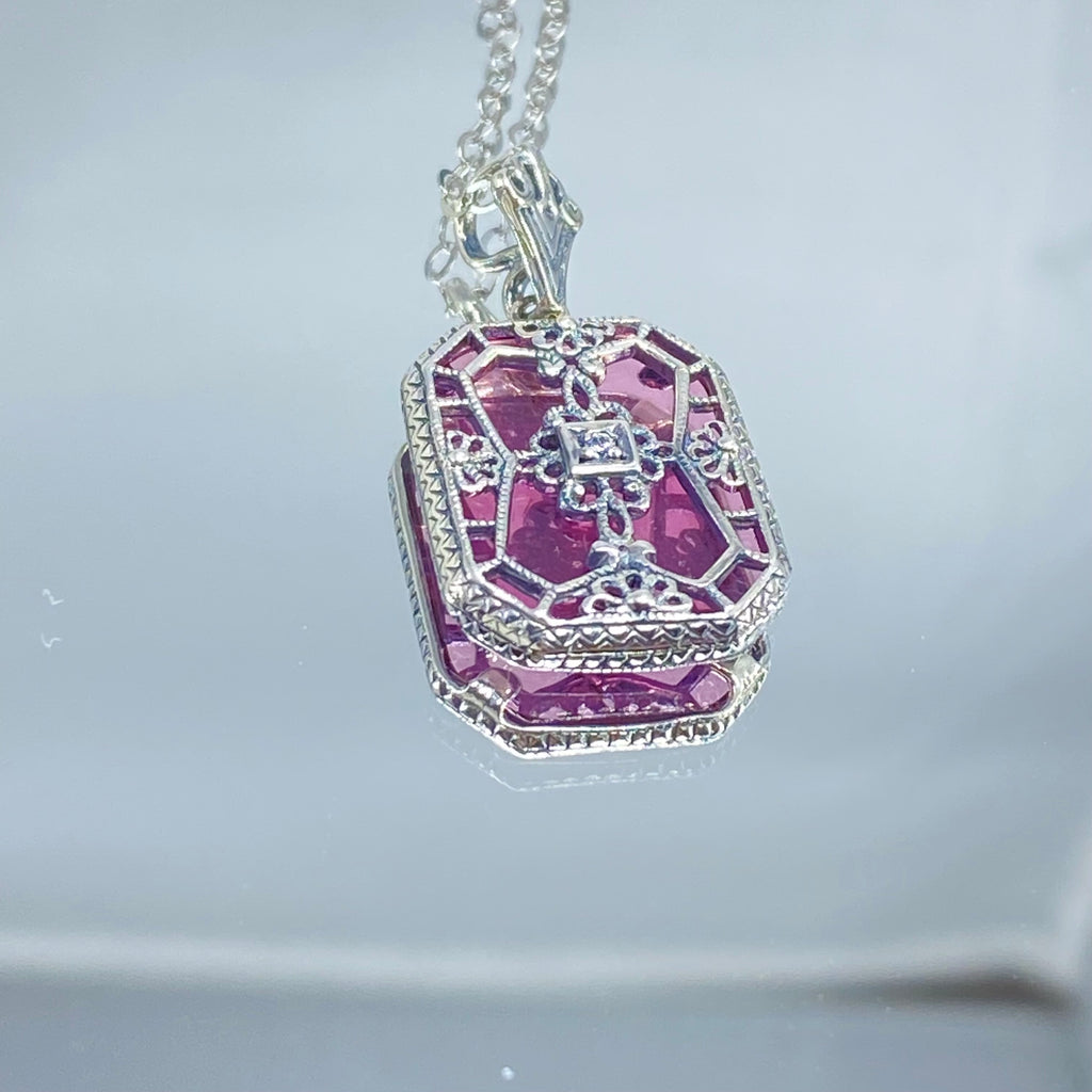 Pink Camphor Glass pendant with a CZ gem inset in the center, sterling silver filigree edging and across the glass face in window pane style, Silver Embrace Jewelry, P203
