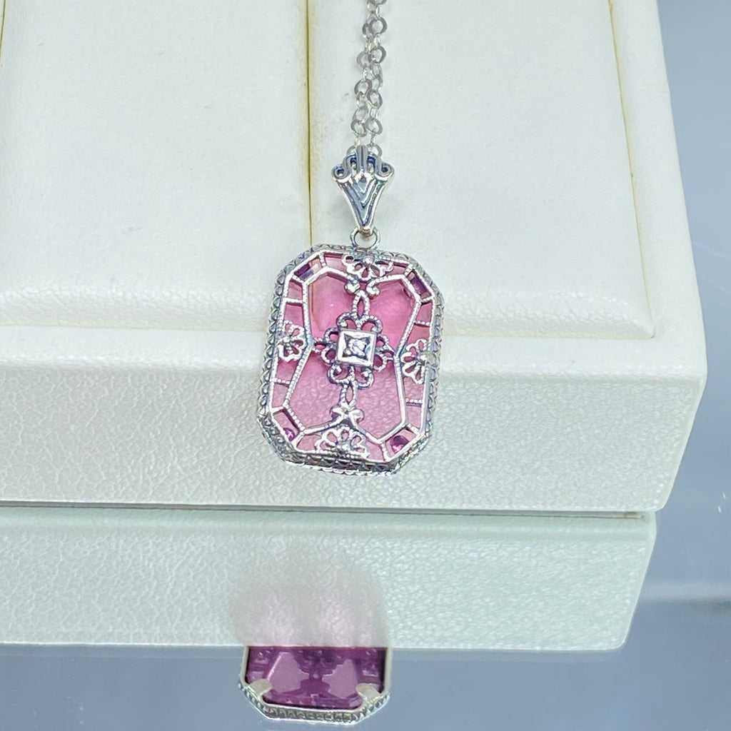 Pink Camphor Glass pendant with a CZ gem inset in the center, sterling silver filigree edging and across the glass face in window pane style, Silver Embrace Jewelry, P203
