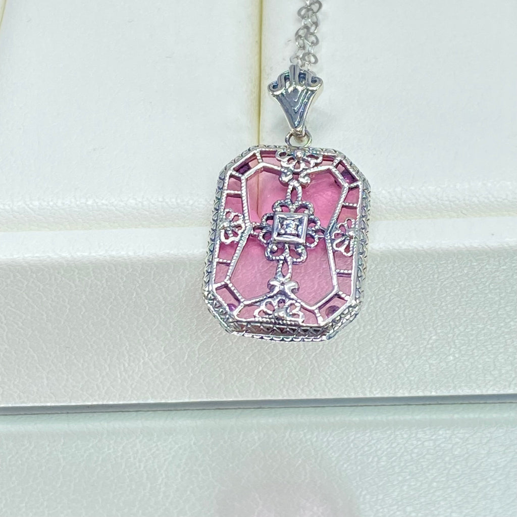 Pink Camphor Glass pendant with a CZ gem inset in the center, sterling silver filigree edging and across the glass face in window pane style, Silver Embrace Jewelry, P203
