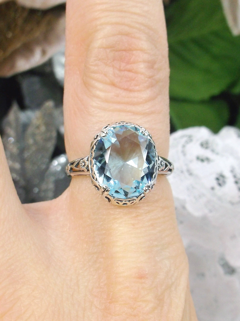 Aquamarine Ring, Sky Blue simulated oval gemstone, Sterling Silver floral filigree, Edward design #D70z, top view on finger