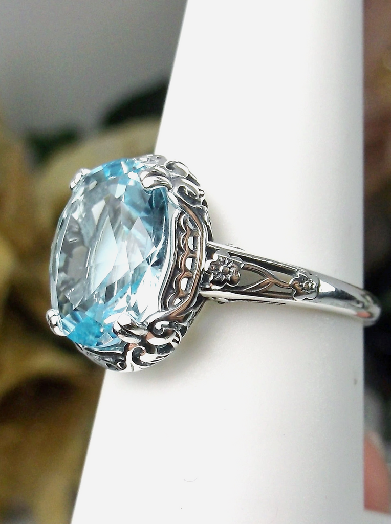 Aquamarine Ring, Sky Blue simulated oval gemstone, Sterling Silver floral filigree, Edward design #D70z, offset side view
