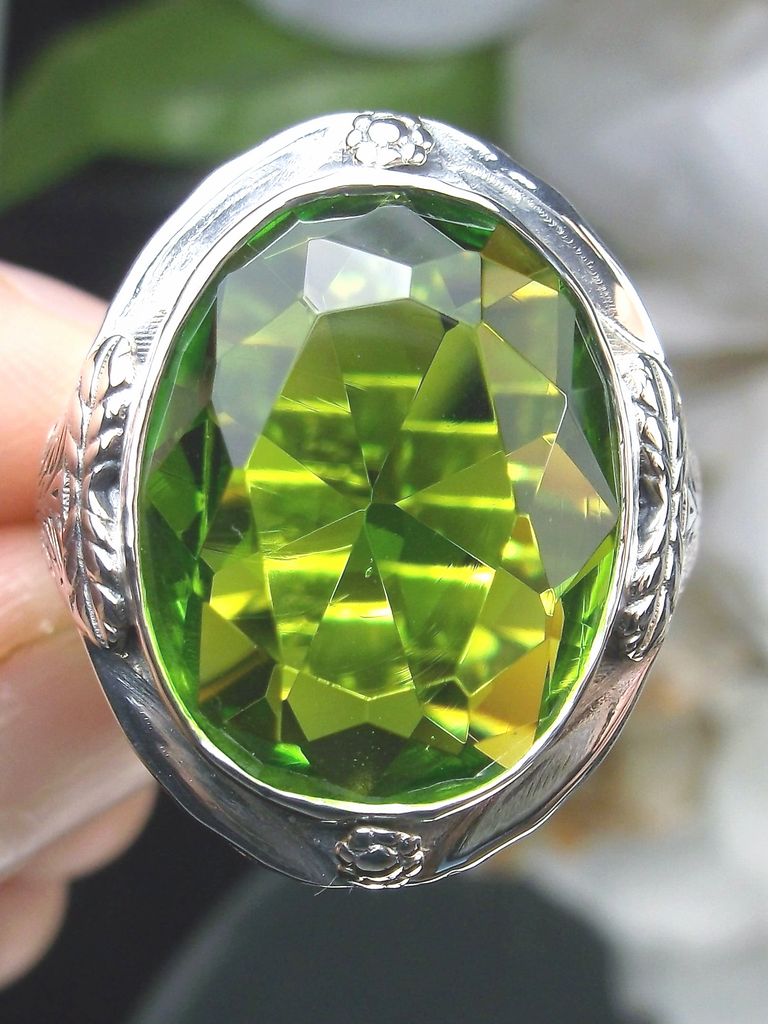 a close up of a person holding a green ring