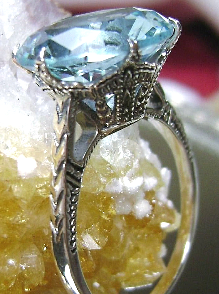sky blue aquamarine solitaire ring with silver etched filigree band and setting