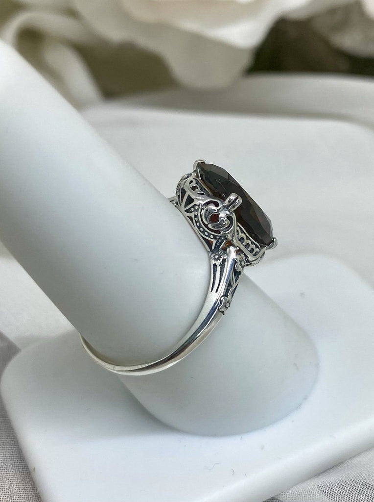 Simulated Red Garnet Ring, Sterling Silver floral filigree, Edward Design #D70,  side view on a ring holder
