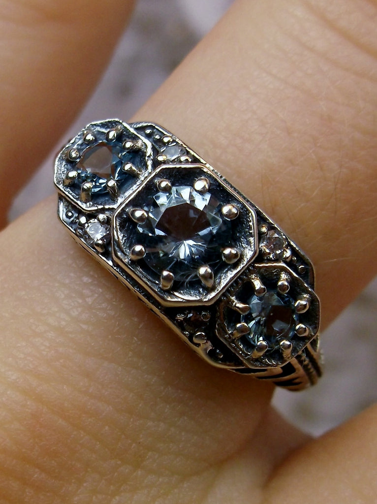 Art deco style ring with three sky blue aquamarine gems set in sterling silver filigree