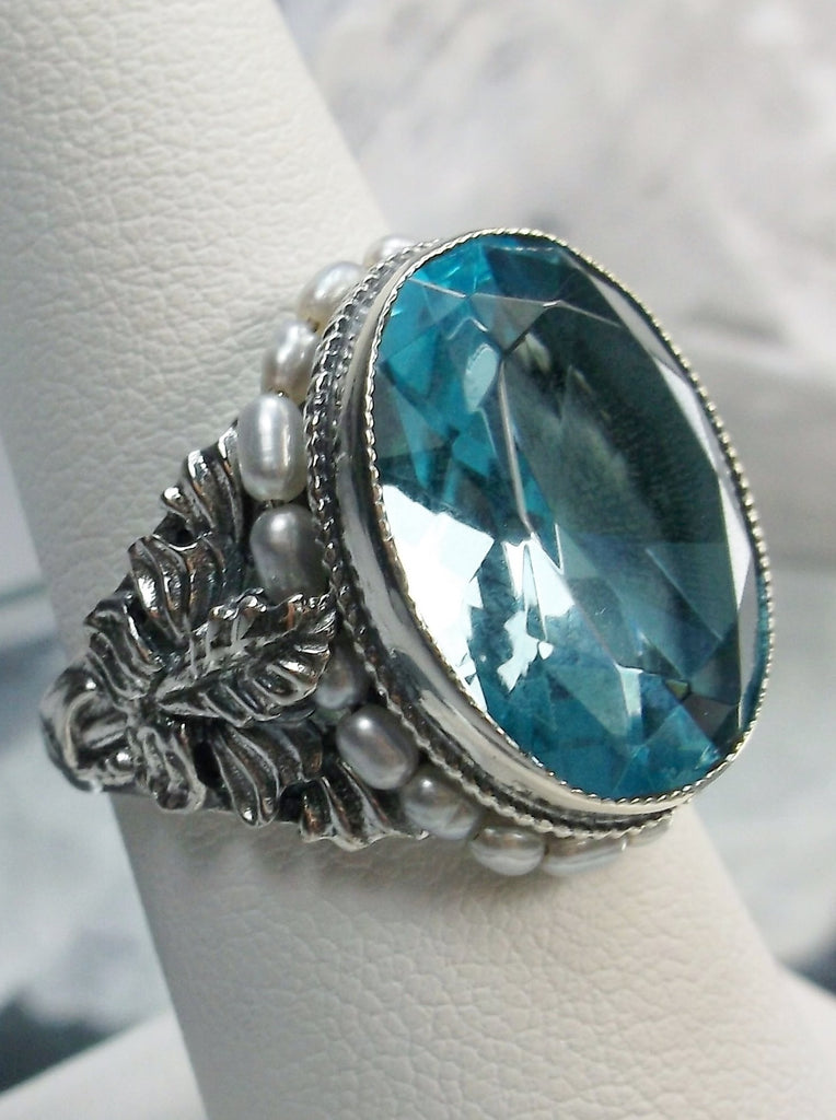Aquamarine Blue Art Nouveau style sterling silver ring, oval sky blue gem with seed pearls encircling the gem edge and palm tree silver filigree accents on each side of the band