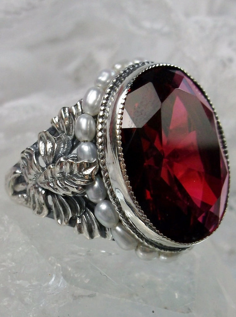 Ruby Red Art Nouveau style sterling silver ring, oval ruby red gem with seed pearls encircling the gem edge and palm tree silver filigree accents on each side of the band