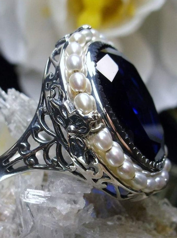 Sapphire Ring, Seed Pearls surround and accent the simulated oval stone with sterling silver Victorian filigree