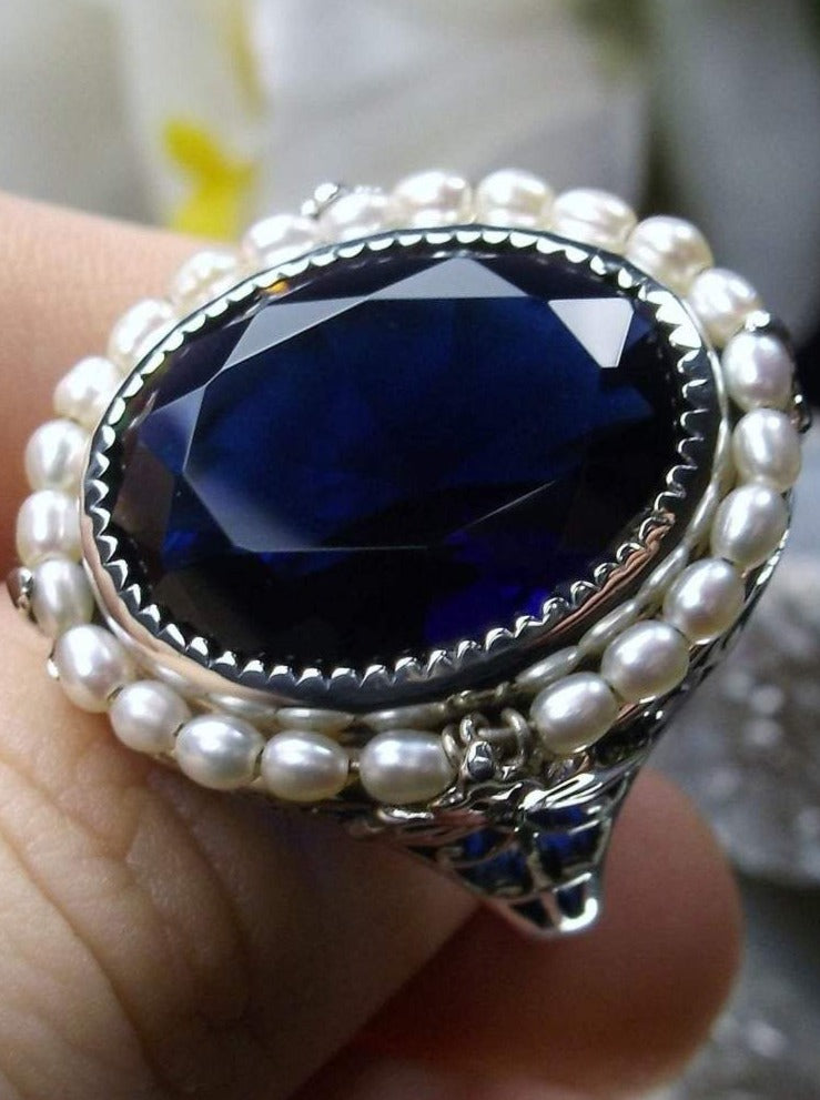 Sapphire Ring, Seed Pearls surround and accent the simulated oval stone with sterling silver Victorian filigree