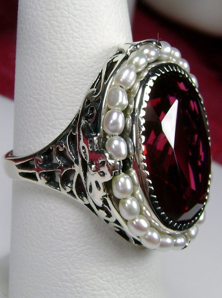 Ruby Ring, Seed Pearls surround and accent the simulated oval stone with sterling silver Victorian filigree