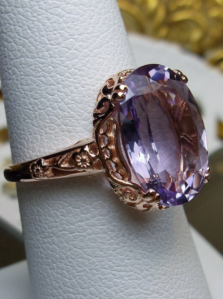 Side view of a Natural Purple Amethyst Rose Gold plated Sterling Silver Filigree Ring, Edward Design#70 on a ring holder