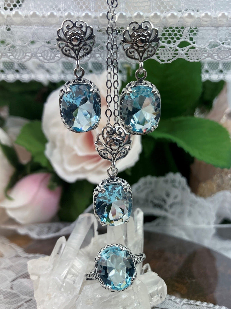 aquamarine jewelry set with sky blue oval stones and antique floral filigree, includes earrings with floral posts, pendant with chain and floral bail and antique reproduction ring, Edward Design#70z