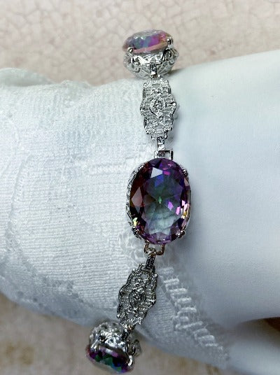 Edwardian bracelet with oval mystic topaz gems, sterling silver filigree and a lobster claw clasp