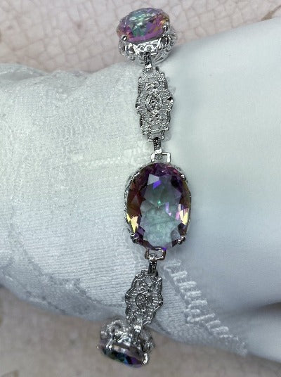 Edwardian bracelet with oval mystic topaz gems, sterling silver filigree and a lobster claw clasp