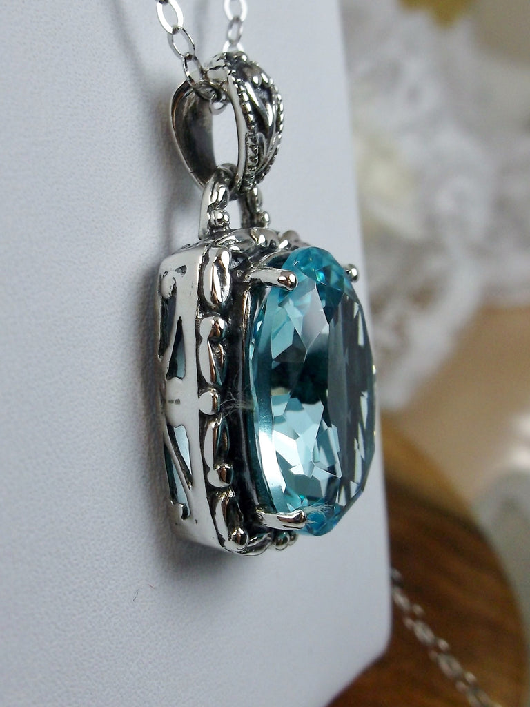 Blue Topaz Pendant, oval sky blue topaz gemstone surrounded by sterling silver leaf accent detail, creating a charming Art Nouveau pendant