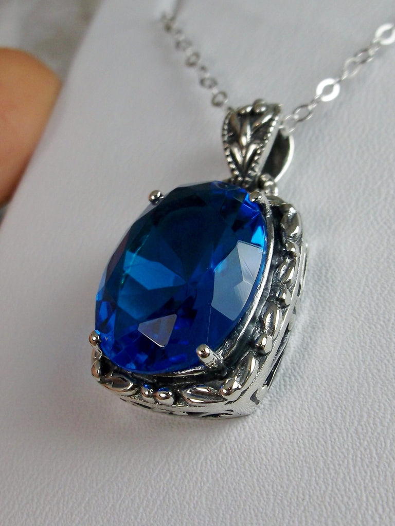 Swiss Blue Topaz Pendant, oval swiss blue topaz gemstone surrounded by sterling silver leaf accent detail, creating a charming Art Nouveau pendant, Silver Embrace Jewelry