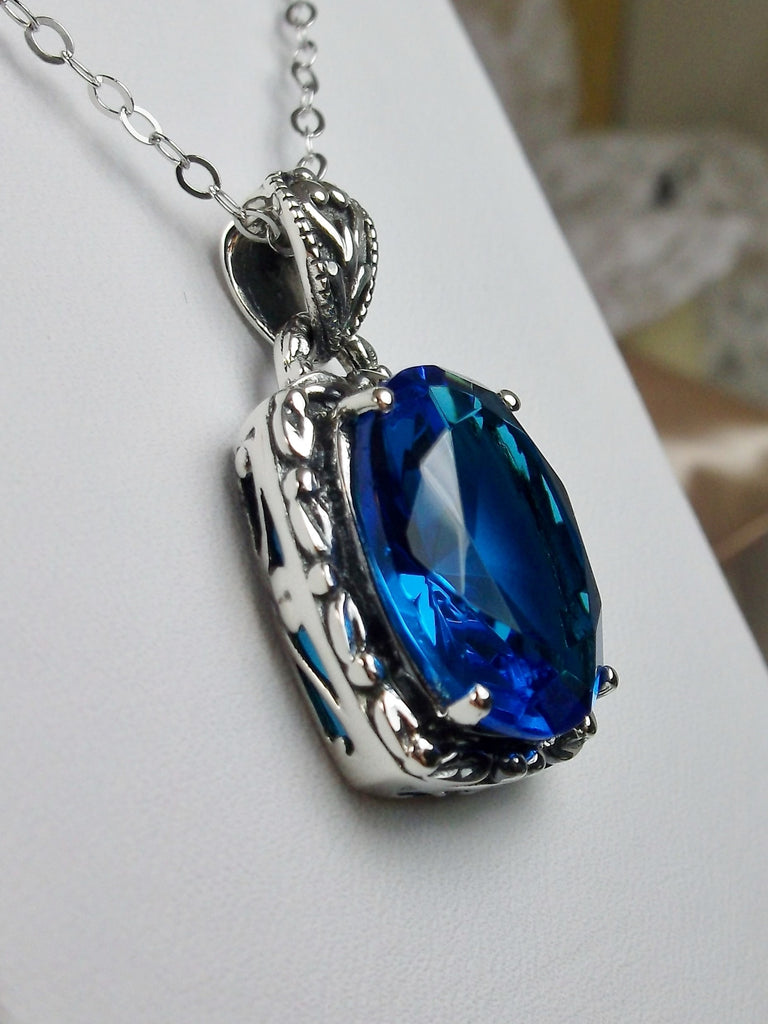 Swiss Blue Pendant, Leaf Accent Pendant, oval faceted gemstone surrounded by sterling silver leaf accent detail, creating a charming Art Nouveau pendant, Sterling silver Filigree, Silver Embrace Jewelry P120