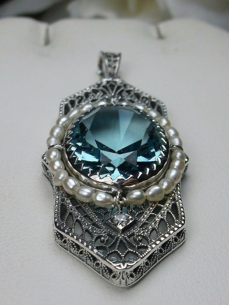 Aquamarine Pendant, Art Deco 1930s jewelry, seed pearl accents surround an oval gemstone with a sterling silver filigree background. two White CZs adorn above and below the large brilliant focal gemstone, Silver Embrace Jewelry necklace