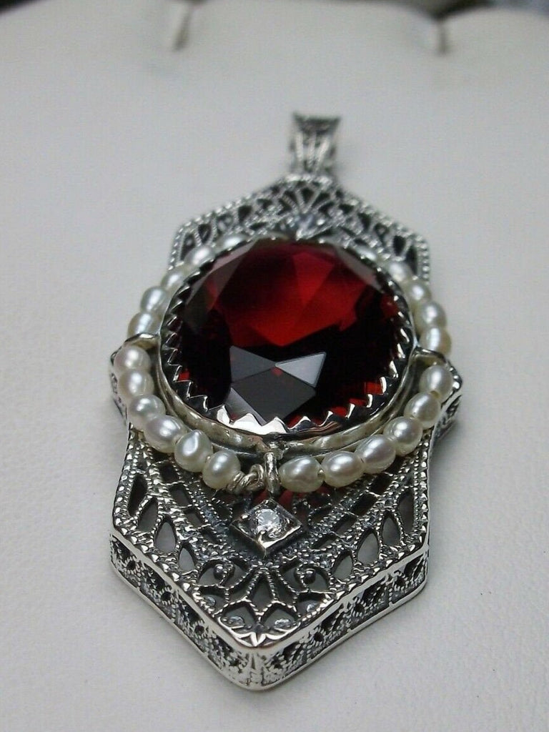 Red Ruby Pendant, Art Deco 1930s jewelry, seed pearl accents surround an oval gemstone with a sterling silver filigree background. two White CZs adorn above and below the large brilliant focal gemstone, Silver Embrace Jewelry necklace