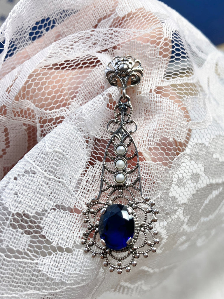 Sapphire Blue pendant, lavaliere design pendant with an oval stone set in a floral background of sterling silver filigree, three lovely seed pearls set above the focal gemstone suspended by a floral bail, Silver Embrace Jewelry