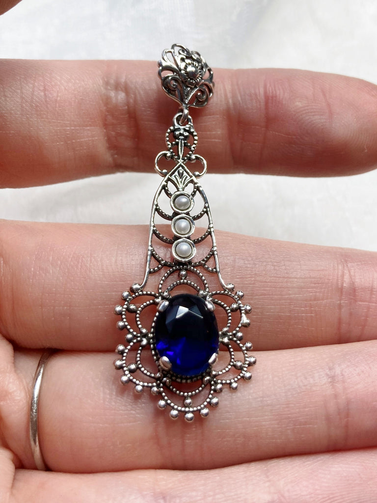 Sapphire Blue pendant, lavaliere design pendant with an oval stone set in a floral background of sterling silver filigree, three lovely seed pearls set above the focal gemstone suspended by a floral bail, Silver Embrace Jewelry