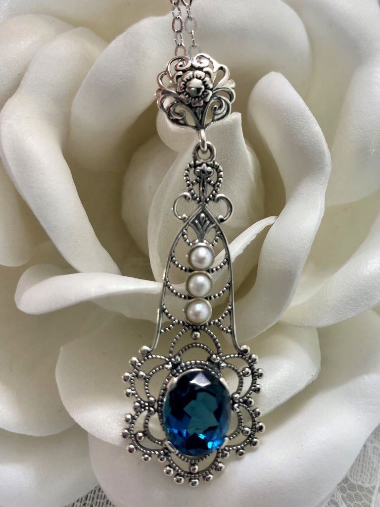 London Blue pendant, lavaliere design pendant with an oval stone set in a floral background of sterling silver filigree, three lovely seed pearls set above the focal gemstone suspended by a floral bail, Silver Embrace Jewelry