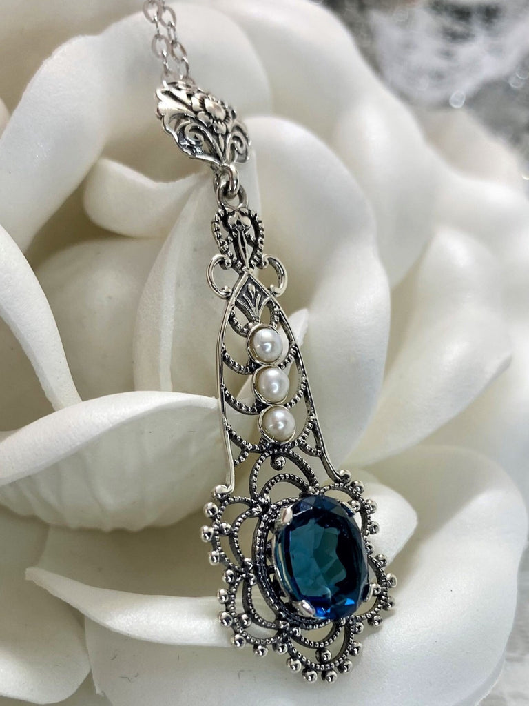 London Blue pendant, lavaliere design pendant with an oval stone set in a floral background of sterling silver filigree, three lovely seed pearls set above the focal gemstone suspended by a floral bail, Silver Embrace Jewelry