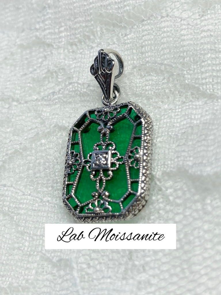 Emerald Green Glass pendant with a Moissanite gem inset in the center, sterling silver filigree edging and across the glass face in window pane style
