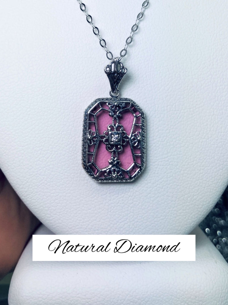 Pink Camphor Glass pendant with a Diamond gem inset in the center, sterling silver filigree edging and across the glass face in window pane style