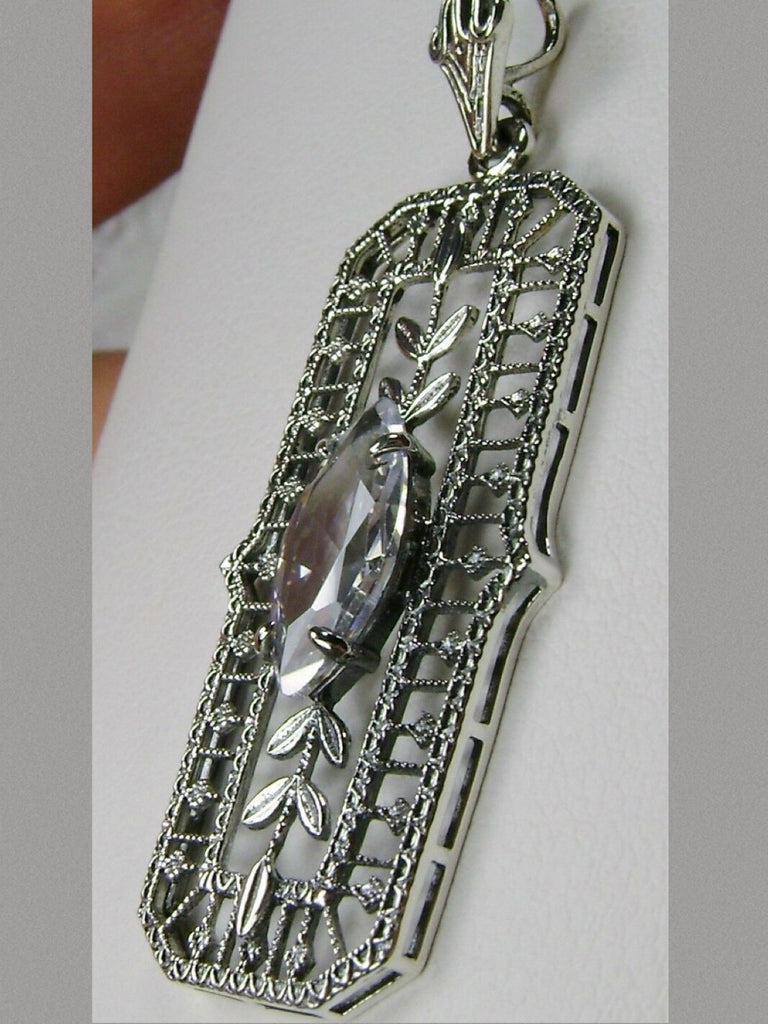 White CZ art deco pendant, center stone is marquise cut white CZ, delicate floral filigree surrounds the entire pendant and there are leaf accents above and below the center gemstone, Silver Embrace Jewelry