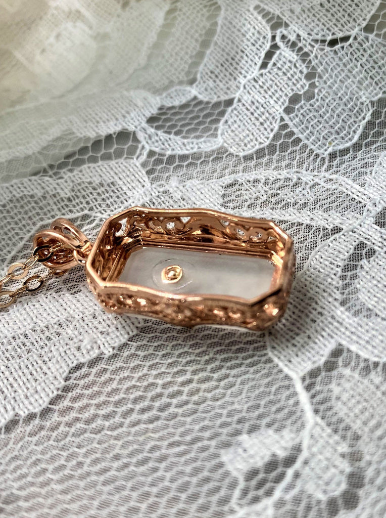 White Camphor Glass pendant, with rose gold filigree edging with three prongs, etched floral detail on the face of the glass and a CZ accent gem, Silver Embrace Jewelry