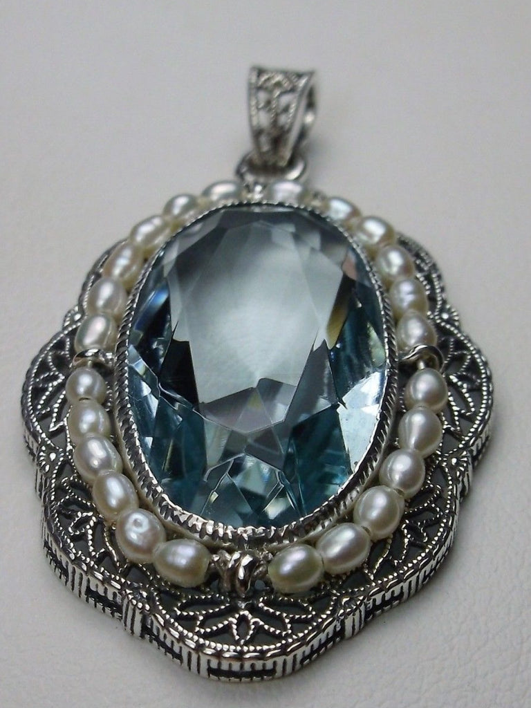 aquamarine pendant with large sky blue oval gemstone surrounded by seed pearls and antique floral filigree, Silver Embrace Jewelry