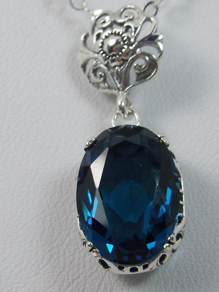 London Blue Topaz Pendant Necklace, london blue pendant, with a vibrant blue oval stone set in floral sterling silver filigree, 4 prongs hold the gem in place, Silver Embrace Jewelry
