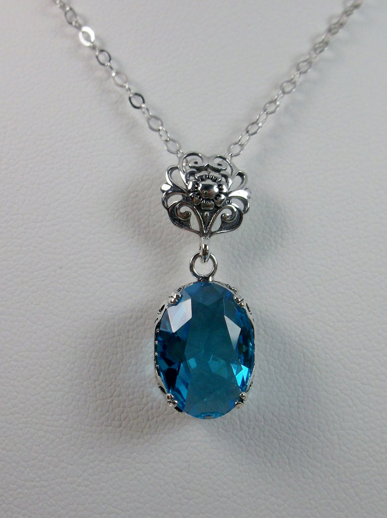 Swiss Blue Pendant Necklace, blue pendant, with a swiss blue oval stone set in floral sterling silver filigree, 4 prongs hold the gem in place, Silver Embrace Jewelry