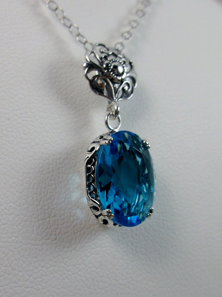 Swiss Blue Pendant Necklace, blue pendant, with a swiss blue oval stone set in floral sterling silver filigree, 4 prongs hold the gem in place, Silver Embrace Jewelry