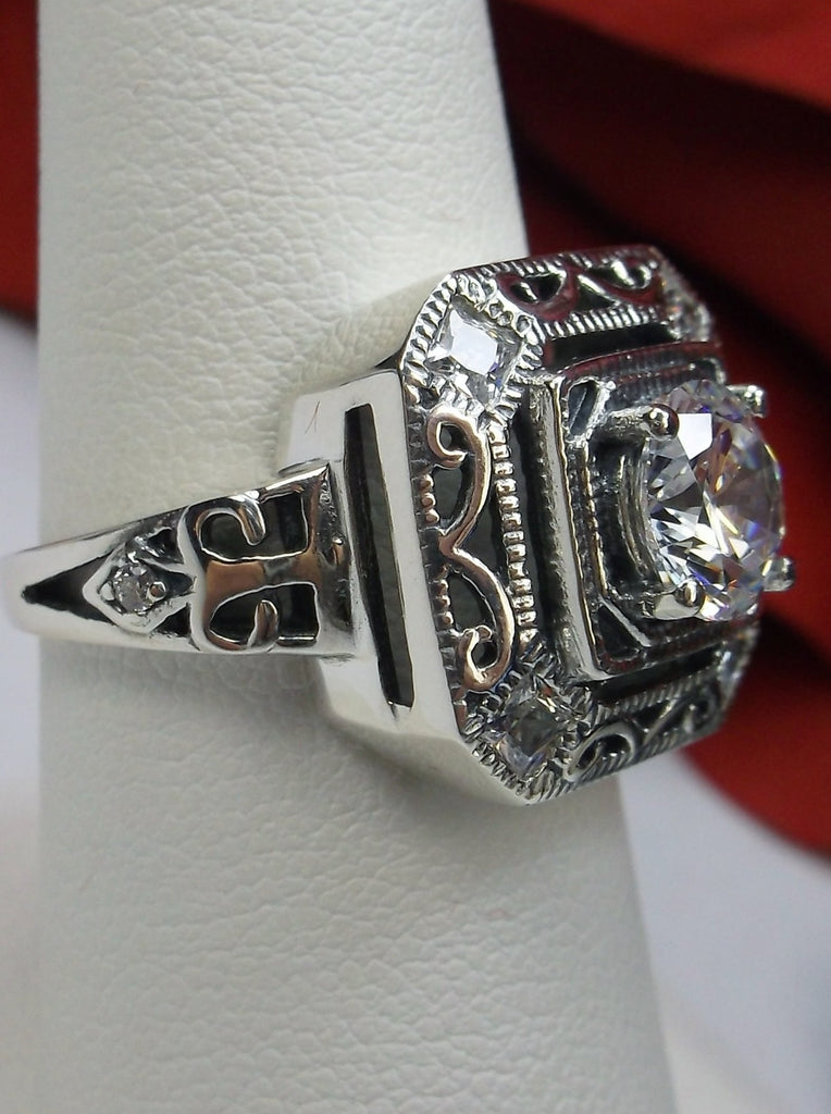 art deco style ring with a white CZ, faux diamond center stone and 4 faux diamond gems in each corner of the octagonal filigree