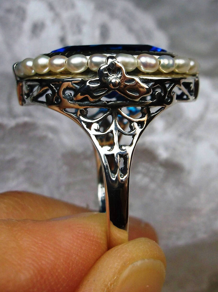 Swiss Blue Topaz Ring, Seed Pearls surround and accent the simulated oval stone with sterling silver Victorian filigree