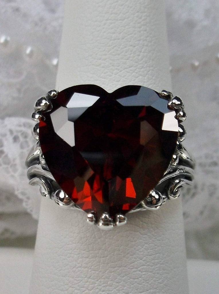 red garnet cubic zirconia ring with a heart shaped gem and gothic style sterling silver filigree