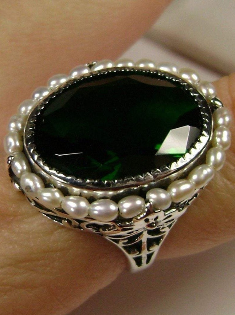 Emerald Ring, Seed Pearls surround and accent the simulated oval stone with sterling silver Victorian filigree
