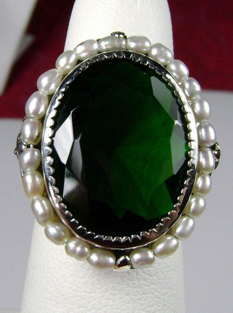 Emerald Ring, Seed Pearls surround and accent the simulated oval stone with sterling silver Victorian filigree