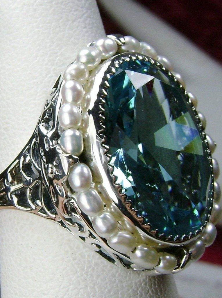 Aquamarine Ring, Seed Pearls surround and accent the simulated oval stone with sterling silver Victorian filigree