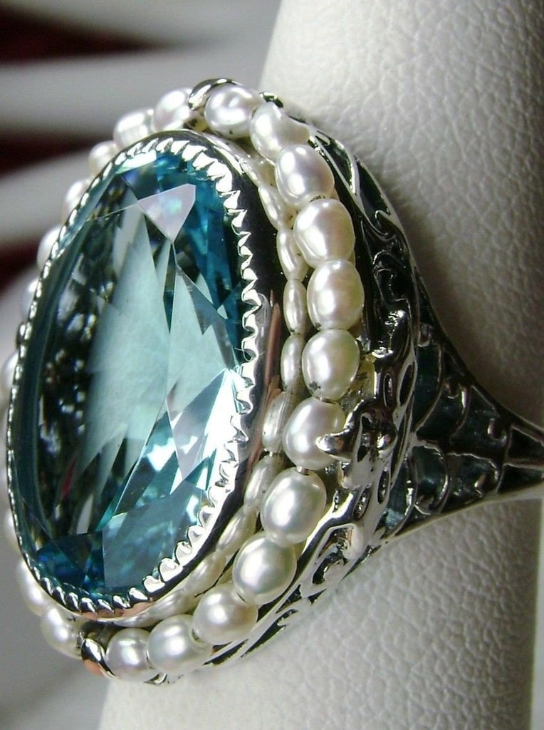 Aquamarine Ring, Seed Pearls surround and accent the simulated oval stone with sterling silver Victorian filigree