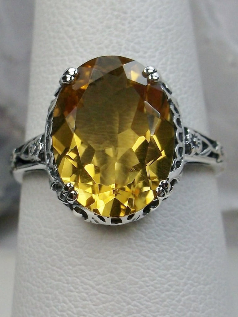 Natural Citrine Ring, Oval yellow citrine gemstone, sterling silver floral filigree, Edward Design #D70, top view on a ring holder
