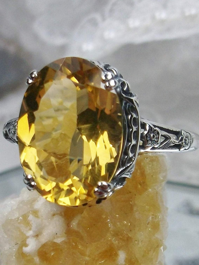 Natural Citrine Ring, Oval yellow citrine gemstone, sterling silver floral filigree, Edward Design #D70, front side view on a yellow crystal stone