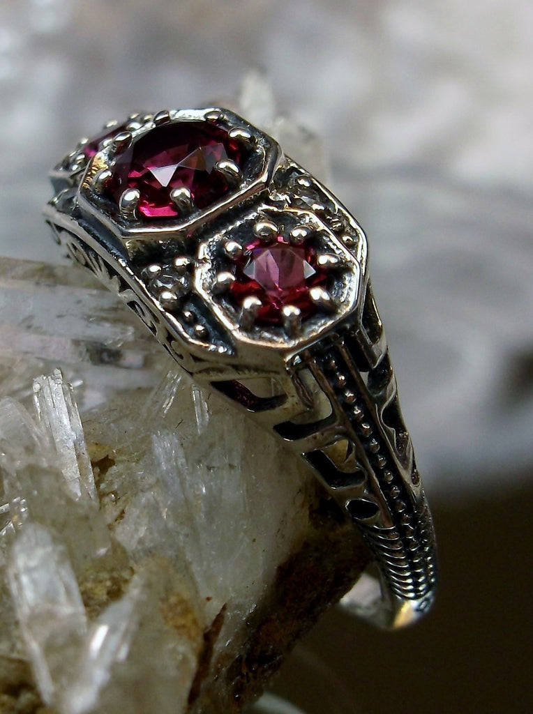 Art deco style ring with three red ruby gems set in sterling silver filigree
