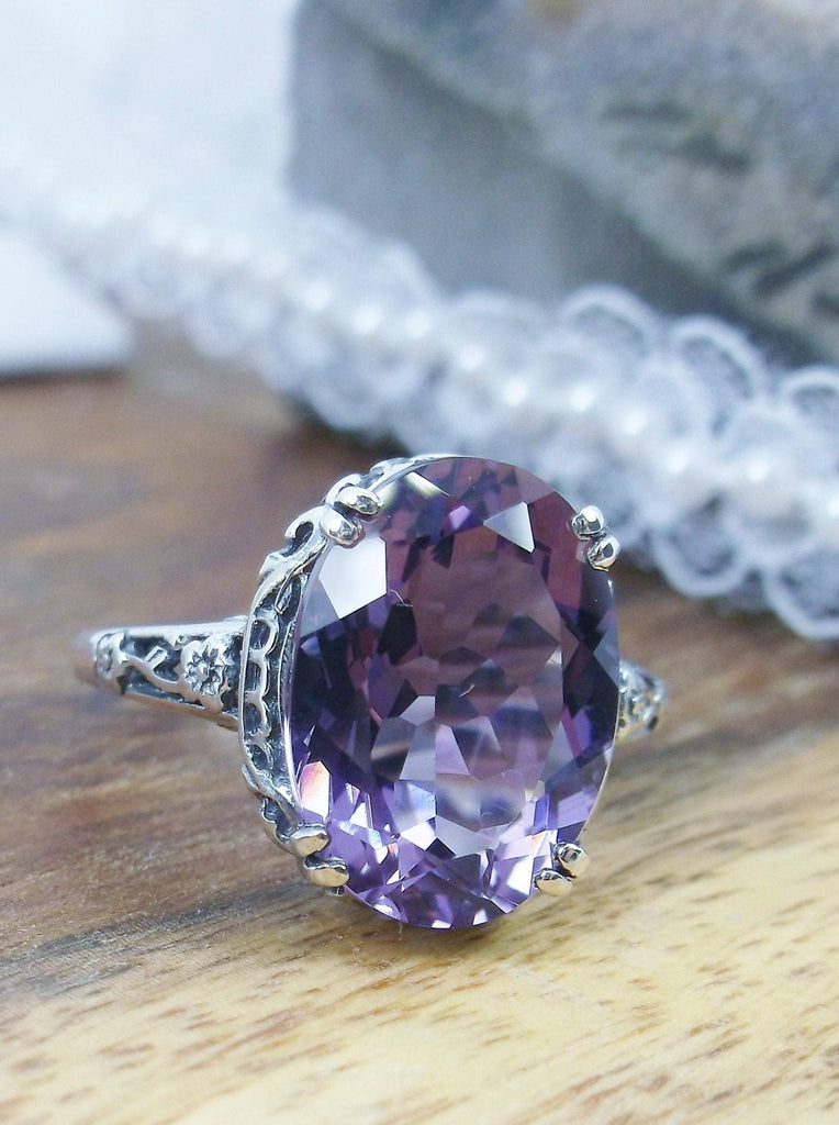 front angle view of Natural Purple Amethyst Sterling Silver Filigree Ring, Edward Design#70 on a wooden surface