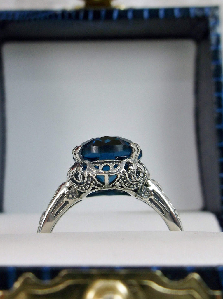 London Blue Topaz Ring, oval simulated topaz, sterling silver floral filigree, Edward design #70z, side view in a ring box