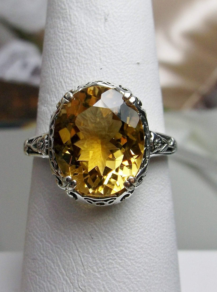 Natural Citrine Ring, Oval yellow citrine gemstone, sterling silver floral filigree, Edward Design #D70z, front view on a ring holder
