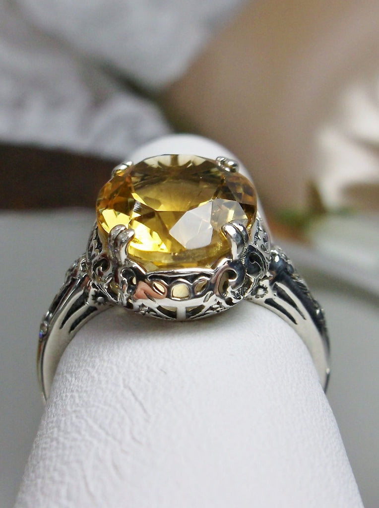 Natural Citrine Ring, Oval yellow citrine gemstone, sterling silver floral filigree, Edward Design #D70z, front side view on a ring holder